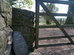 A "Not all those who wander are lost" sign post to mark the end of the Tolkien Trail